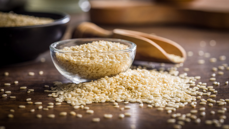 A small glass bowl of white sesame seeds