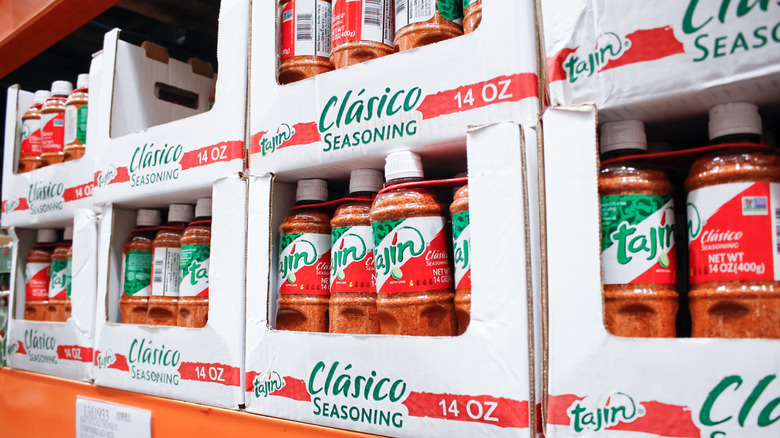White cardboard boxes of Tajín bottles on a shelf at Costco