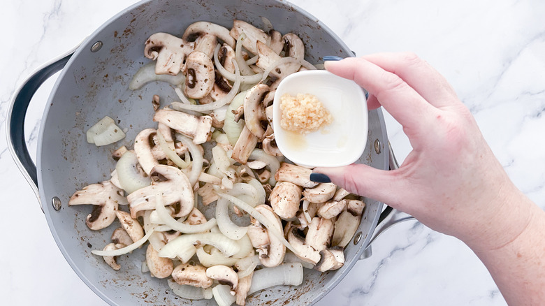 mushrooms and onions in skillet 