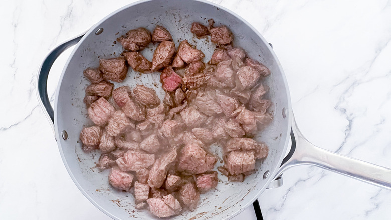 beef cubes in skillet 