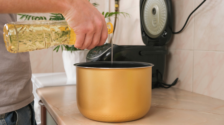 pouring oil in slow cooker