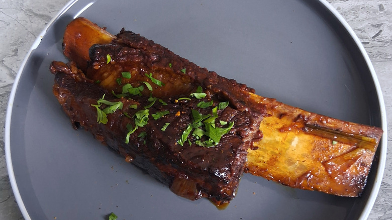 Slow-cooked short rib with rosemary garnish