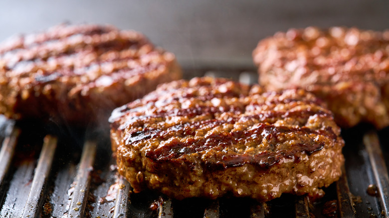 A smash burger with fries and sauce