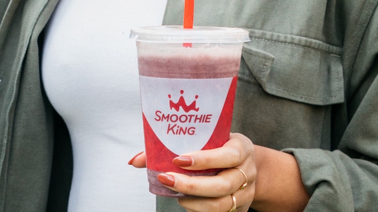 person holding smoothie king smoothie