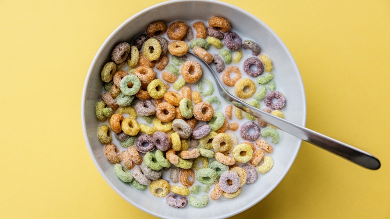 bowl of multi-color cereal on yellow background