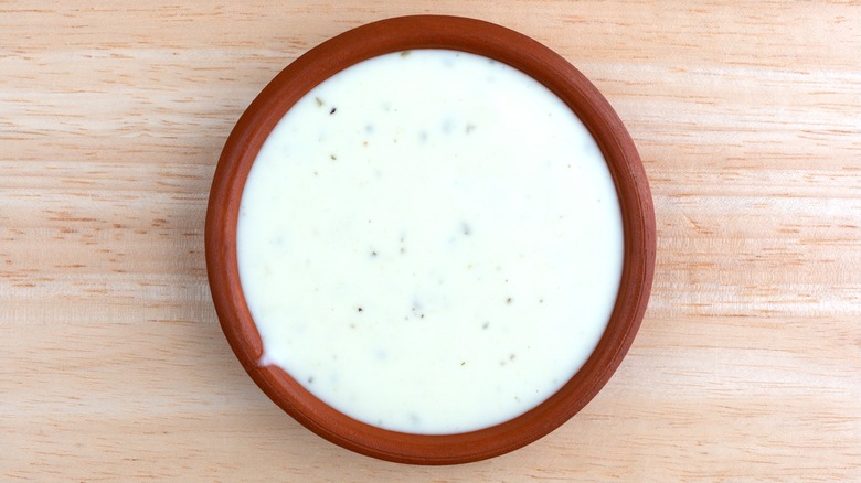 container of ranch dressing on wooden surface