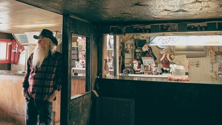 Denzel Irwin "Santa" leans against doorframe at Santa's Pub in Nashville