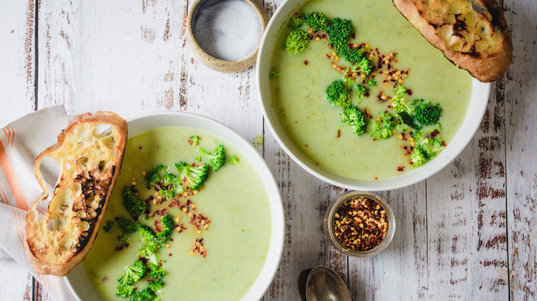 Two bowls of broccoli soup
