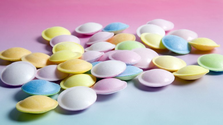 Colorful satellite wafer candies on an ombre pink background