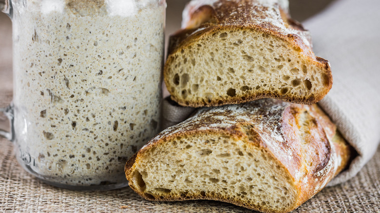 Starter and sliced sourdough bread