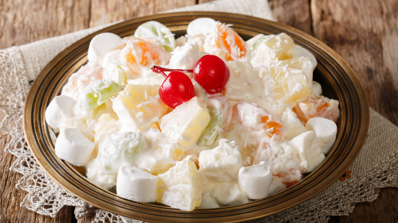 A bowl full of Ambrosia Salad on a white doily