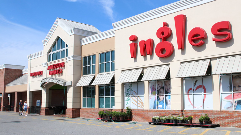 Angled view of an Ingles Market storefront under a bright blue sky
