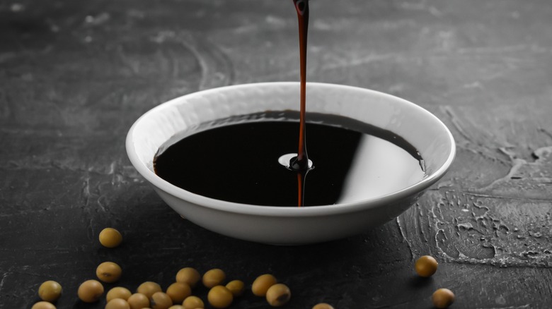 soy sauce pouring into bowl