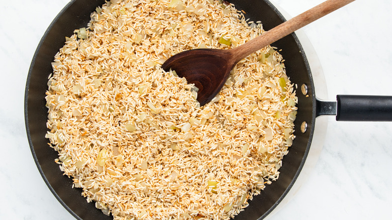 rice and onions in pan