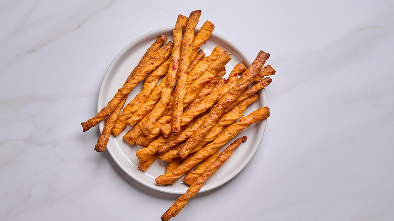 pile of cheese straws on a plate