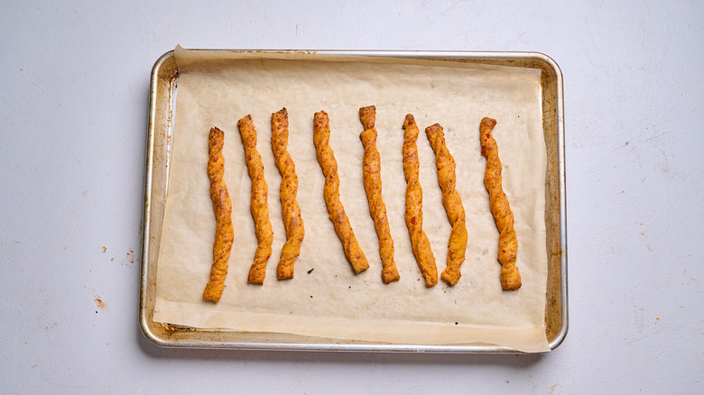 baked cheese straws on a sheet tray