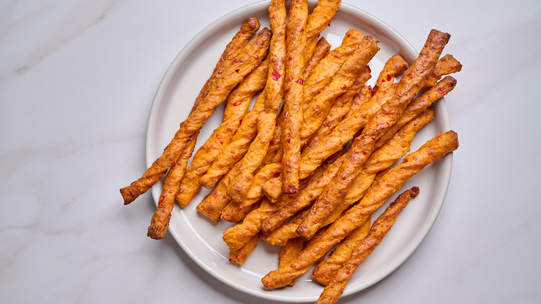 cheese straws piled on a plate