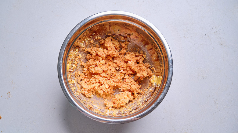 mixing tomato paste into butter mixture