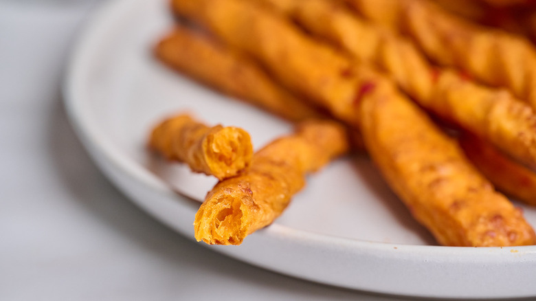 cheese straw broken in half to show the inside