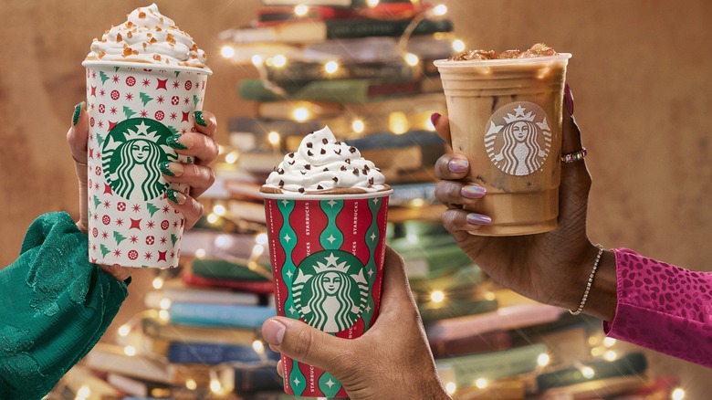 Hands holding Starbucks winter seasonal beverages