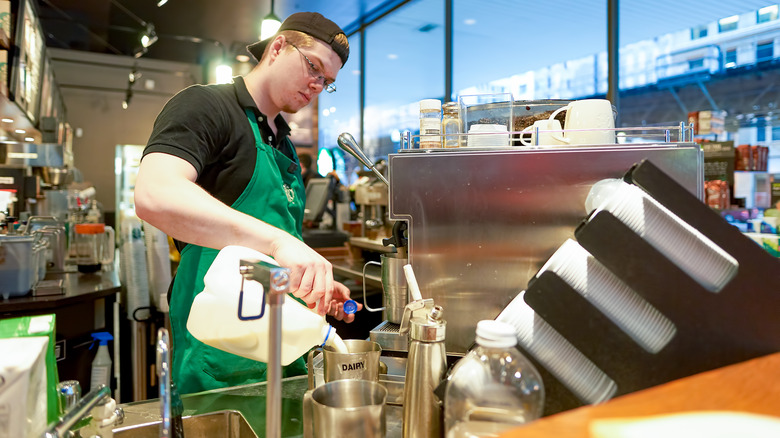 starbucks barista pouring milk