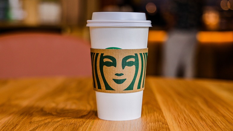 Starbucks grande cup on barista counter