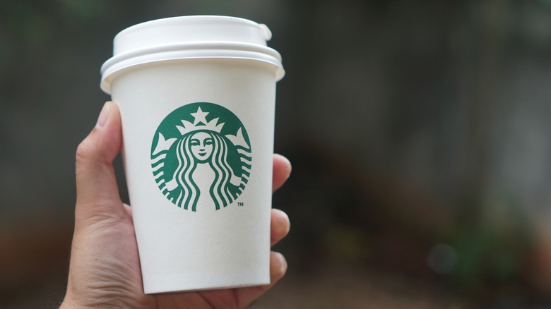 Starbucks coffee cup held in a hand