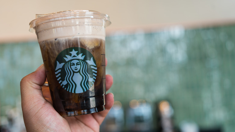 Hand holding Starbucks cold brew coffee