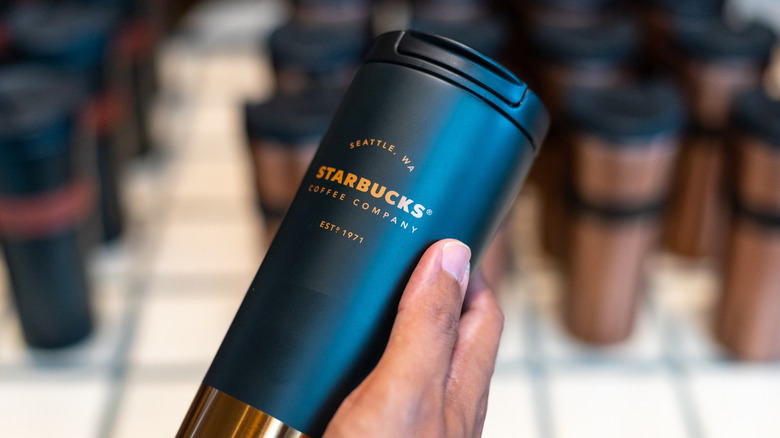 Starbucks tumbler in hand