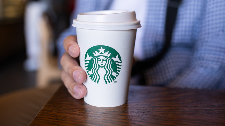 Person holding a Starbucks cup