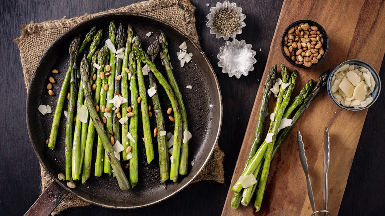 Asparagus on skillet with toppings