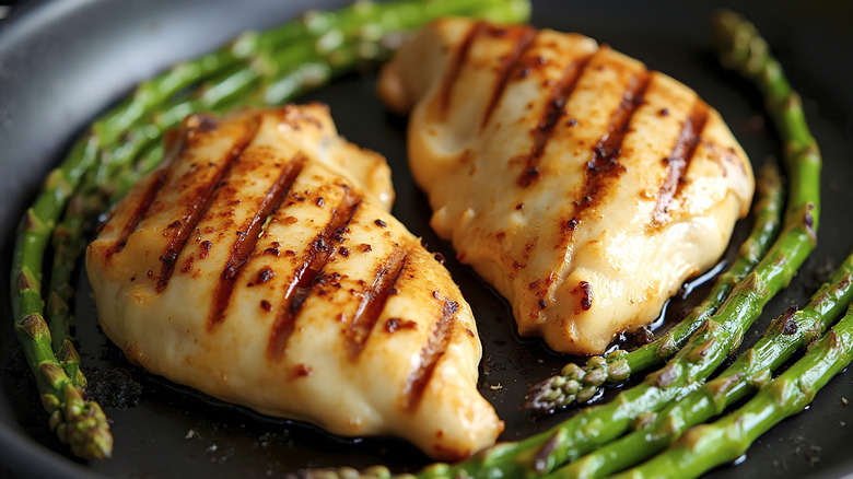 Grilled chicken breasts with asparagus spears