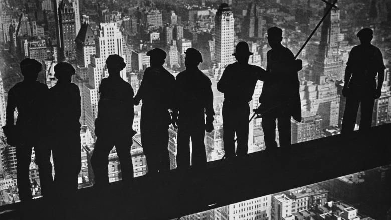 Steelworkers standing on beam