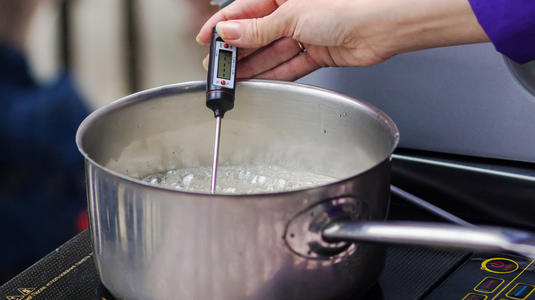 Instant read thermometer in a pot of water.