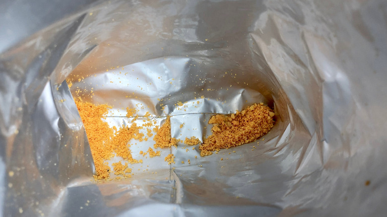 Doritos crumbs at the bottom of a bag.