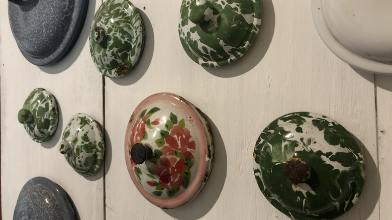 Vintage pot lids hanging on wall