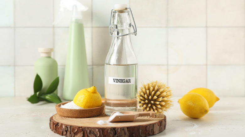 Bottle of vinegar and halved lemons