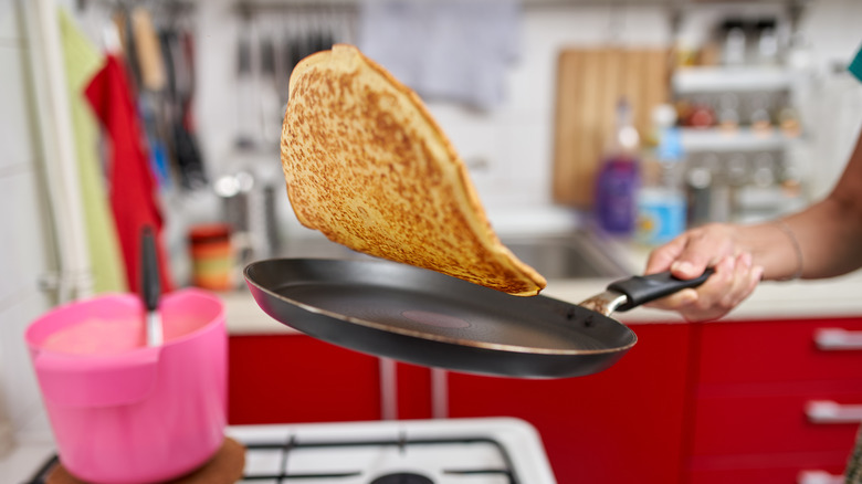 A person flipping a pancake