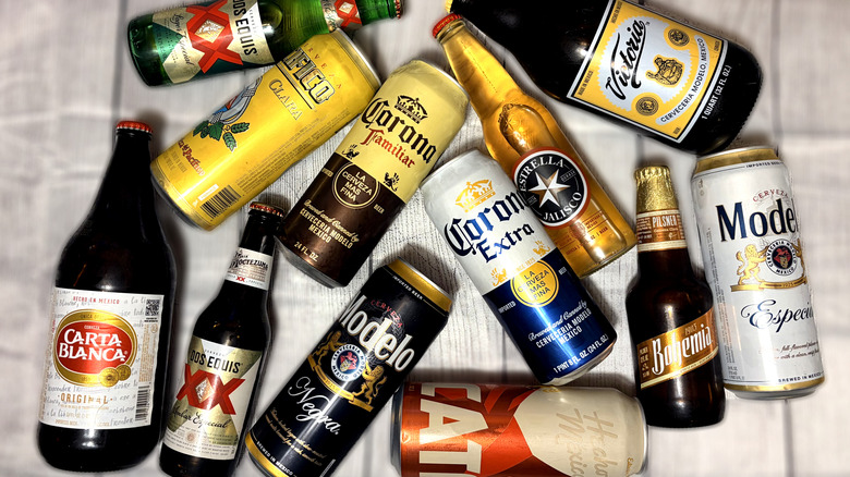 Selection of cans and bottles of Mexican beer arranged on a table