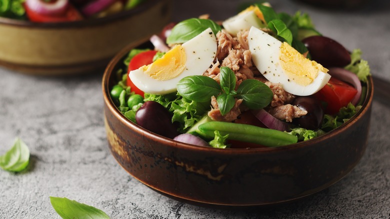 Niçoise salad in brown bowl