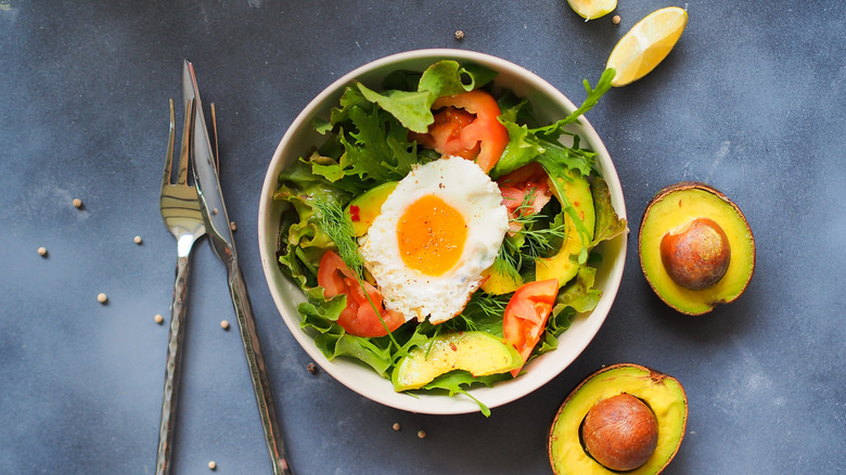 Salad topped with egg 