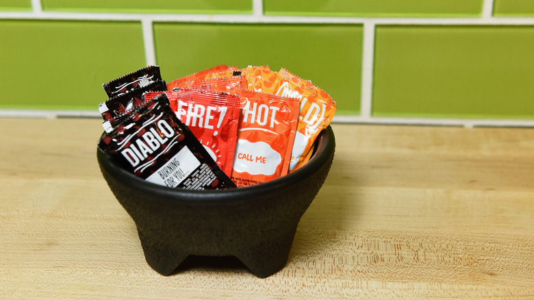 A bowl full of various Taco Bell sauces