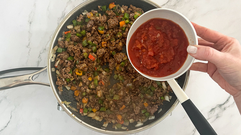 salsa going into skillet 