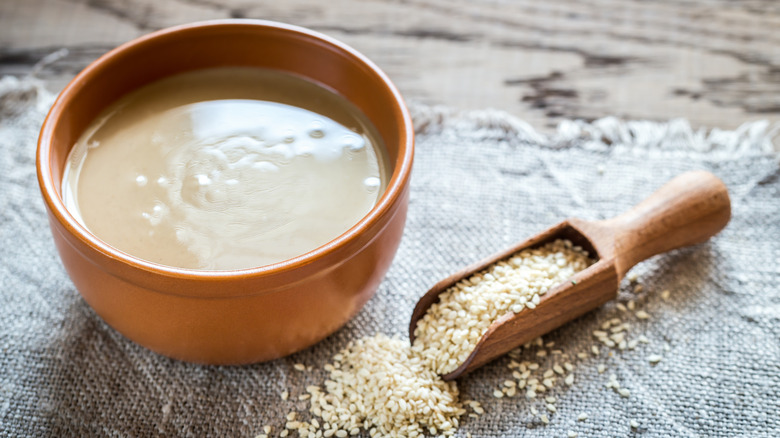 Wooden bowl of tahini with sesame seeds