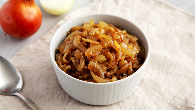 Caramelized onions in a white bowl placed on a table