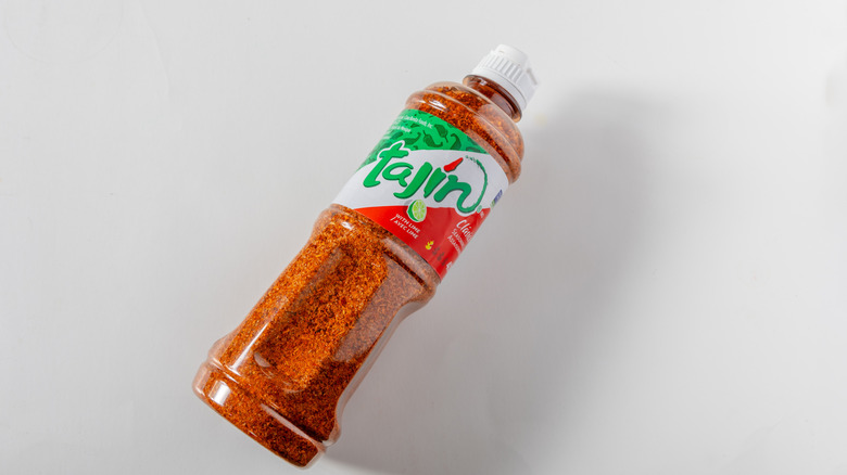 A bottle of Tajín seasoning on a white table