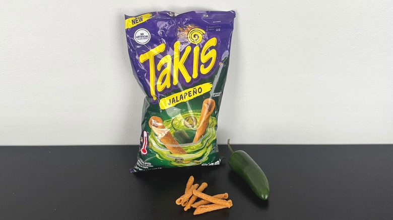 A bag of Jalapeño Takis with a fresh jalapeño