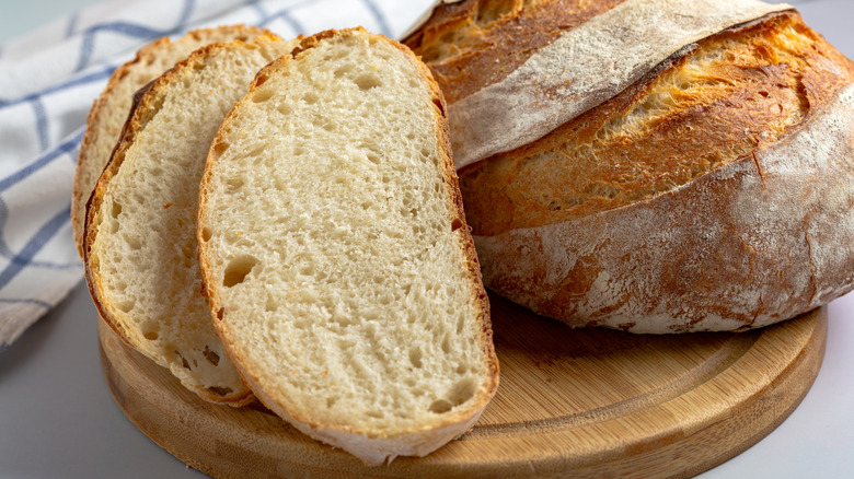 Slices of sourdough bread next to loaf