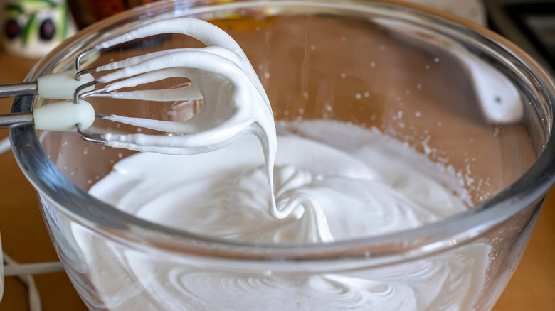 Whipped egg whites forming stiff peaks