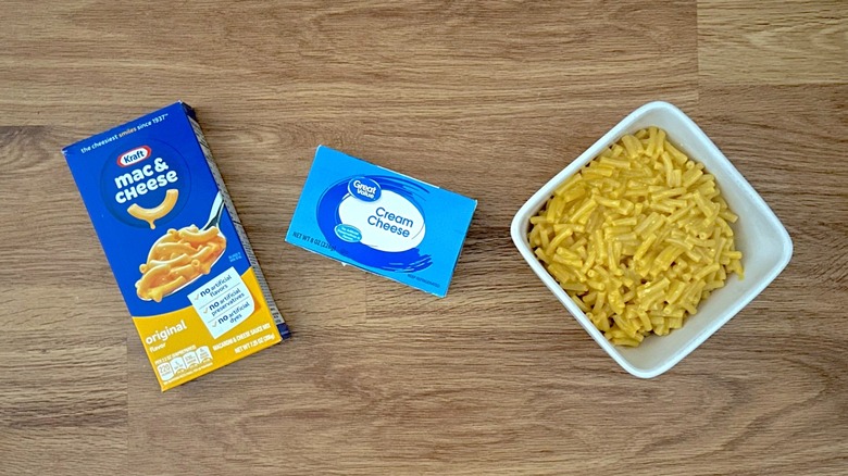 Box of Kraft Mac & Cheese, box of Great Value Cream Cheese, white bowl of cooked mac and cheese